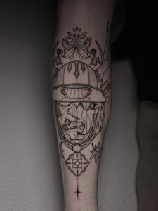 Kyle, fineline tattoo specialist, working on a detailed script tattoo in Tampa studio